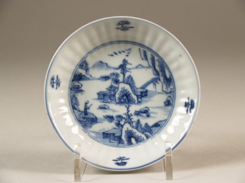 Schotel met geribbelde wand met op plat decor in onderglazuurblauw blauw van rivierlandschap
